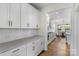 Bright kitchen featuring white cabinets with gold hardware and stainless steel appliances at 8008 Hudson Mill Dr, Waxhaw, NC 28173
