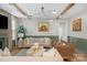 Bright living room featuring hardwood floors, exposed wood beams, fireplace with mantel, and stylish neutral furnishings at 8008 Hudson Mill Dr, Waxhaw, NC 28173