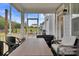 Relaxing screened-in porch offering a cozy seating area, string lights, and views of the lush backyard at 8008 Hudson Mill Dr, Waxhaw, NC 28173