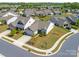 Aerial view of a suburban home with well-manicured lawns, landscaped gardens, and a welcoming driveway at 804 Birdsong Way, Fort Mill, SC 29715