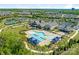 Aerial view features the pool, clubhouse, tennis courts and surrounding landscaping of the community at 804 Birdsong Way, Fort Mill, SC 29715