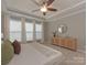 Bright bedroom featuring large windows, a ceiling fan, and neutral decor, offering a relaxing and inviting space at 804 Birdsong Way, Fort Mill, SC 29715