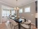 Bright dining room with a modern chandelier is open to a cozy living room at 804 Birdsong Way, Fort Mill, SC 29715