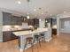 Elegant kitchen with dark wood cabinetry, a center island with stools, and hardwood floors at 804 Birdsong Way, Fort Mill, SC 29715