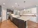 Modern kitchen with a large center island, stainless steel appliances, and white cabinetry at 804 Birdsong Way, Fort Mill, SC 29715