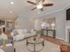 Open living room features a fireplace, wood floors, and comfortable seating at 804 Birdsong Way, Fort Mill, SC 29715