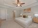 Spacious main bedroom features a ceiling fan, carpet, and ensuite bathroom at 804 Birdsong Way, Fort Mill, SC 29715
