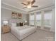 Bright main bedroom features neutral decor, a ceiling fan, and large windows at 804 Birdsong Way, Fort Mill, SC 29715