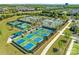Aerial view showcases vibrant pickleball courts in a lively community setting at 804 Birdsong Way, Fort Mill, SC 29715