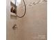 Close-up of a tiled shower featuring neutral tile, a built-in niche, and stylish shower head at 804 Birdsong Way, Fort Mill, SC 29715