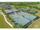 Aerial view of well-maintained tennis courts surrounded by lush greenery at 804 Birdsong Way, Fort Mill, SC 29715