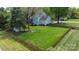 Aerial view of a large, fenced backyard with green grass and mature trees, perfect for outdoor activities at 8517 Sandowne Ln, Huntersville, NC 28078