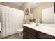 Bathroom with shower curtain, vanity, mirror, and tile floor at 8517 Sandowne Ln, Huntersville, NC 28078