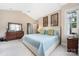 Bright bedroom features a vaulted ceiling, a ceiling fan, a comfy bed, and a wood dresser with mirror at 8517 Sandowne Ln, Huntersville, NC 28078