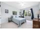 Bedroom features a ceiling fan, a window with curtains, and a bed with blue bedding at 8517 Sandowne Ln, Huntersville, NC 28078