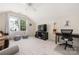 Bonus room features a ceiling fan, a window with curtains, TV, comfortable furniture, desk, and neutral carpeting at 8517 Sandowne Ln, Huntersville, NC 28078