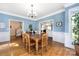 Charming dining room with hardwood floors and wainscoting, seamlessly connected to other living spaces at 8517 Sandowne Ln, Huntersville, NC 28078