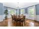 Dining room with hardwood floors, wainscoting, and large windows that provide ample natural light at 8517 Sandowne Ln, Huntersville, NC 28078
