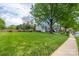 Expansive front lawn with mature trees and a sidewalk, showcasing the neighborhood's peaceful atmosphere at 8517 Sandowne Ln, Huntersville, NC 28078