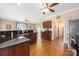 Open-concept kitchen featuring granite countertops, hardwood floors, and stainless steel refrigerator at 8517 Sandowne Ln, Huntersville, NC 28078