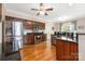 Well-equipped kitchen with stainless steel appliances, granite countertops, and rich wood cabinetry at 8517 Sandowne Ln, Huntersville, NC 28078