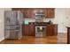 Gourmet kitchen featuring stainless steel appliances and beautiful wood cabinetry and hardwood floors at 8517 Sandowne Ln, Huntersville, NC 28078