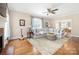 Inviting living room featuring hardwood floors, a fireplace, and large windows with natural light at 8517 Sandowne Ln, Huntersville, NC 28078