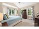 Bright main bedroom with vaulted ceiling, multiple windows, and neutral carpeting at 8517 Sandowne Ln, Huntersville, NC 28078