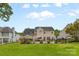 Landscaped backyard featuring a kidney-shaped pool, fenced yard, and lush lawn at 879 Knightsbridge Rd, Fort Mill, SC 29708