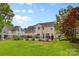 Backyard showcasing in-ground pool, outdoor dining, and a well-manicured lawn at 879 Knightsbridge Rd, Fort Mill, SC 29708