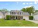 Charming two-story home with a welcoming front porch and lush landscaping at 879 Knightsbridge Rd, Fort Mill, SC 29708