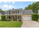 Charming two-story home with a welcoming front porch and lush landscaping at 879 Knightsbridge Rd, Fort Mill, SC 29708