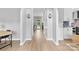 Bright hallway with wood floors leading to the kitchen and a backyard view at 879 Knightsbridge Rd, Fort Mill, SC 29708
