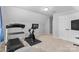 Upstairs home gym featuring an exercise bike, treadmill, and television at 879 Knightsbridge Rd, Fort Mill, SC 29708