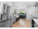 Beautiful kitchen featuring stainless steel appliances, a farmhouse sink, and stylish blue and white cabinetry at 879 Knightsbridge Rd, Fort Mill, SC 29708