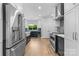 Bright kitchen featuring stainless steel appliances, hardwood floors, and stylish two-tone cabinetry at 879 Knightsbridge Rd, Fort Mill, SC 29708