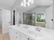 Bright main bathroom features dual vanity, large mirror, glass enclosed shower, and natural light at 879 Knightsbridge Rd, Fort Mill, SC 29708