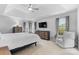 Spacious main bedroom with tray ceiling, large windows, sitting area, and neutral decor at 879 Knightsbridge Rd, Fort Mill, SC 29708