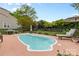 Backyard showcasing a kidney-shaped pool with lounge chairs and green foliage at 879 Knightsbridge Rd, Fort Mill, SC 29708