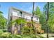 Exterior view of home featuring large deck, brick facade, siding and backyard area at 8937 Penstemons Dr, Charlotte, NC 28215