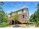 Exterior of home featuring an elevated deck with stairs and a well-maintained backyard at 8937 Penstemons Dr, Charlotte, NC 28215