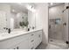Elegant bathroom featuring double vanity, quartz counters, and glass-enclosed shower at 8937 Penstemons Dr, Charlotte, NC 28215