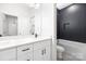Bathroom featuring double vanity, a tub, and tiled walls at 8937 Penstemons Dr, Charlotte, NC 28215