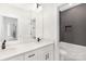 Contemporary bathroom featuring double sink vanity with sleek fixtures and a tiled shower at 8937 Penstemons Dr, Charlotte, NC 28215