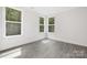 Bright, airy bedroom with large windows offering a view of lush greenery at 8937 Penstemons Dr, Charlotte, NC 28215
