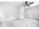 Bright, carpeted bedroom featuring a ceiling fan and double-door closet at 8937 Penstemons Dr, Charlotte, NC 28215
