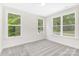 Bright bedroom with three large windows and neutral walls and plush carpet at 8937 Penstemons Dr, Charlotte, NC 28215