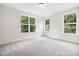 Bright bedroom with ample natural light, neutral walls, and carpeted floors at 8937 Penstemons Dr, Charlotte, NC 28215