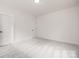 Clean, minimalist bedroom featuring neutral walls, carpet flooring, and two doors at 8937 Penstemons Dr, Charlotte, NC 28215
