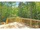 A spacious wooden deck overlooks a serene wooded backdrop, ideal for relaxation at 8937 Penstemons Dr, Charlotte, NC 28215